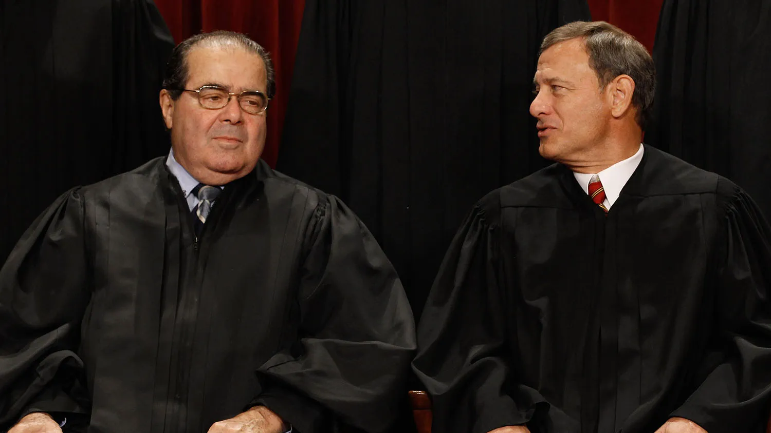 WASHINGTON - OCTOBER 08: U.S. Supreme Court Associate Justice Antonin Scalia (L) and Chief Justice John Roberts talk while posing for photographs in the East Conference Room at the Supreme Court building October 8, 2010 in Washington, DC. This is the first time in history that three women are simultaneously serving on the court. *** Local Caption *** Antonin Scalia;John Roberts
