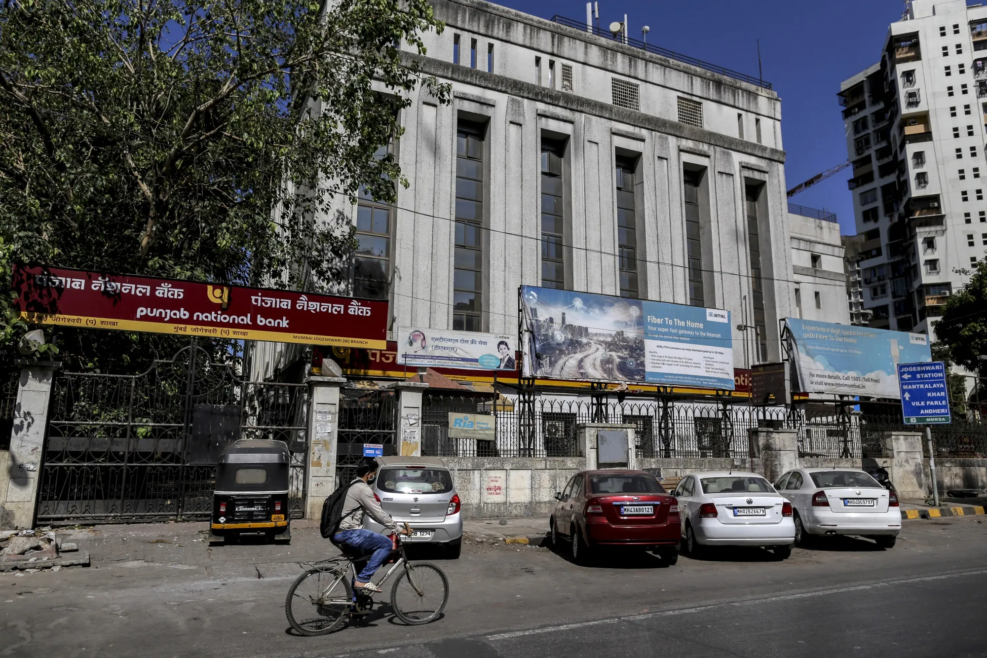 A cyclist rides past a Punjab National Bank&nbsp;branch on a near-empty street in Mumbai, India, on&nbsp;May 4.&nbsp;