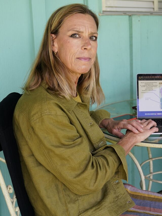 A portrait of Amanda Frye sitting at a table. 