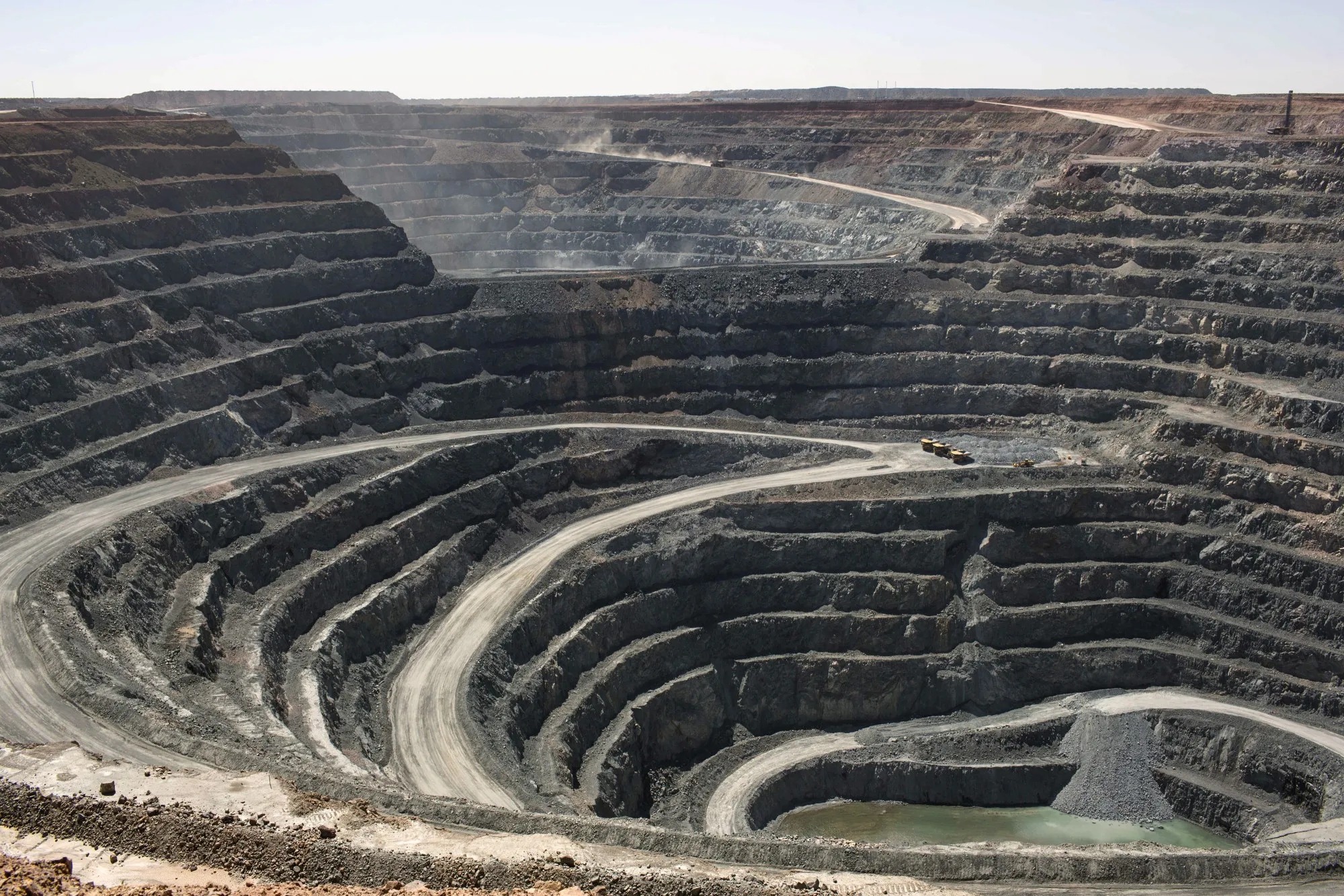 Dump trucks operate in an open pit at the Oyu Tolgoi copper-gold mine, jointly owned by Rio Tinto Group's Turquoise Hill Resources Ltd. unit and state-owned Erdenes Oyu Tolgoi LLC, in Khanbogd, the South Gobi desert, Mongolia, on Saturday, July 23, 2016. Mongolia exported 817,000 tons of copper concentrate in the first half of the year compared with 663,800 tons a year earlier, an increase of 23.1 percent.