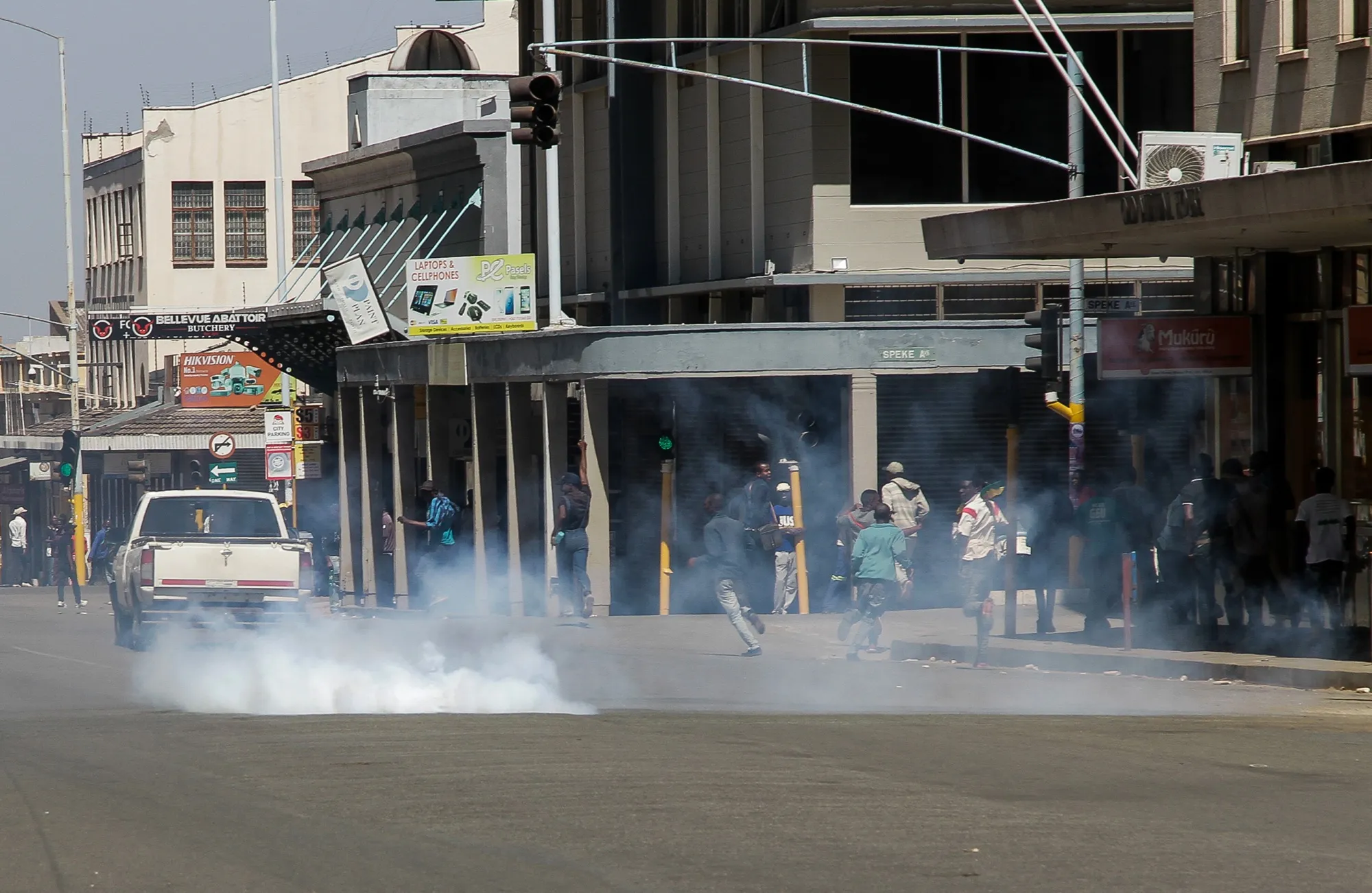Protesters scatter as police fire tear gas on Aug. 16 in Harare, Zimbabwe. The country’s main opposition party, Movement for Democratic Change, called for protests against President Emmerson Mnangagwa and his government’s management of the economy.