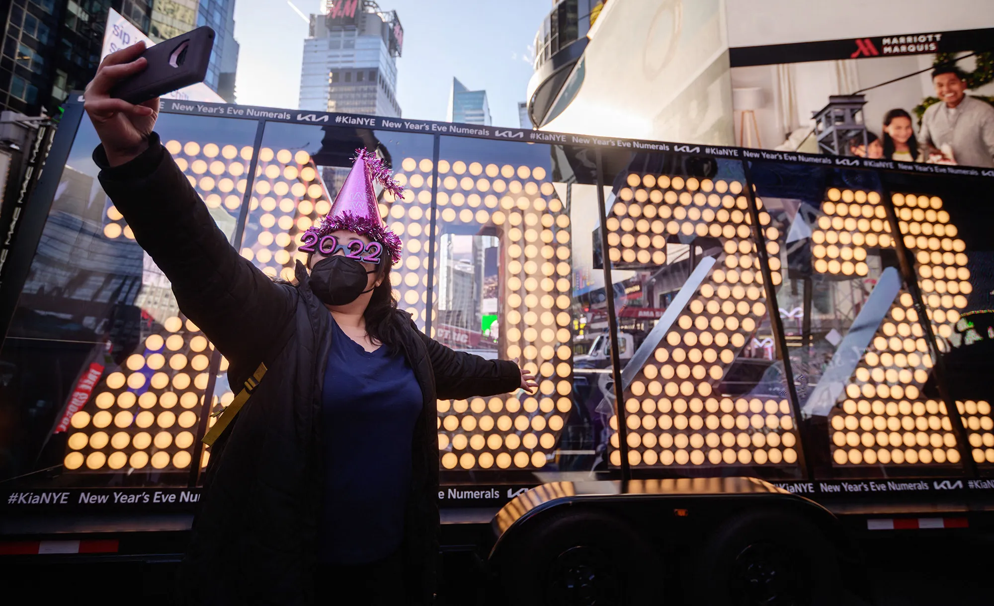 A person takes photos before the 2022 numerals to be used at a new year countdown event in Times Square in New York.