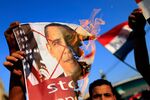 Opponents of Egypt's deposed President Mohamed Mursi burn pictures of U.S. President Barack Obama at a rally in Cairo on July 7