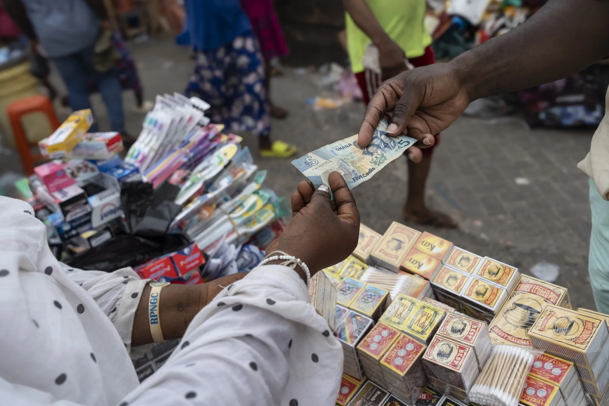 A customer makes a purchase&nbsp;at the Makola market in Accra, Ghana.