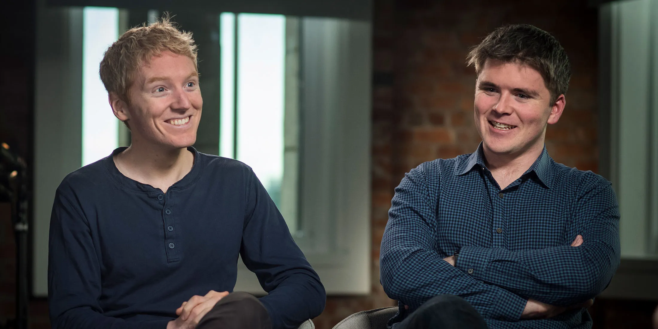 Patrick Collison, chief executive officer and co-founder of Stripe Inc., left, smiles as John Collison, president and co-founder of Stripe Inc., speaks during a Bloomberg Studio 1.0 television interview in San Francisco, California, U.S., on Friday, March 23, 2018. Stripe Inc. provides payment software services and solutions by designing and producing software to process online credit and debit card payments.