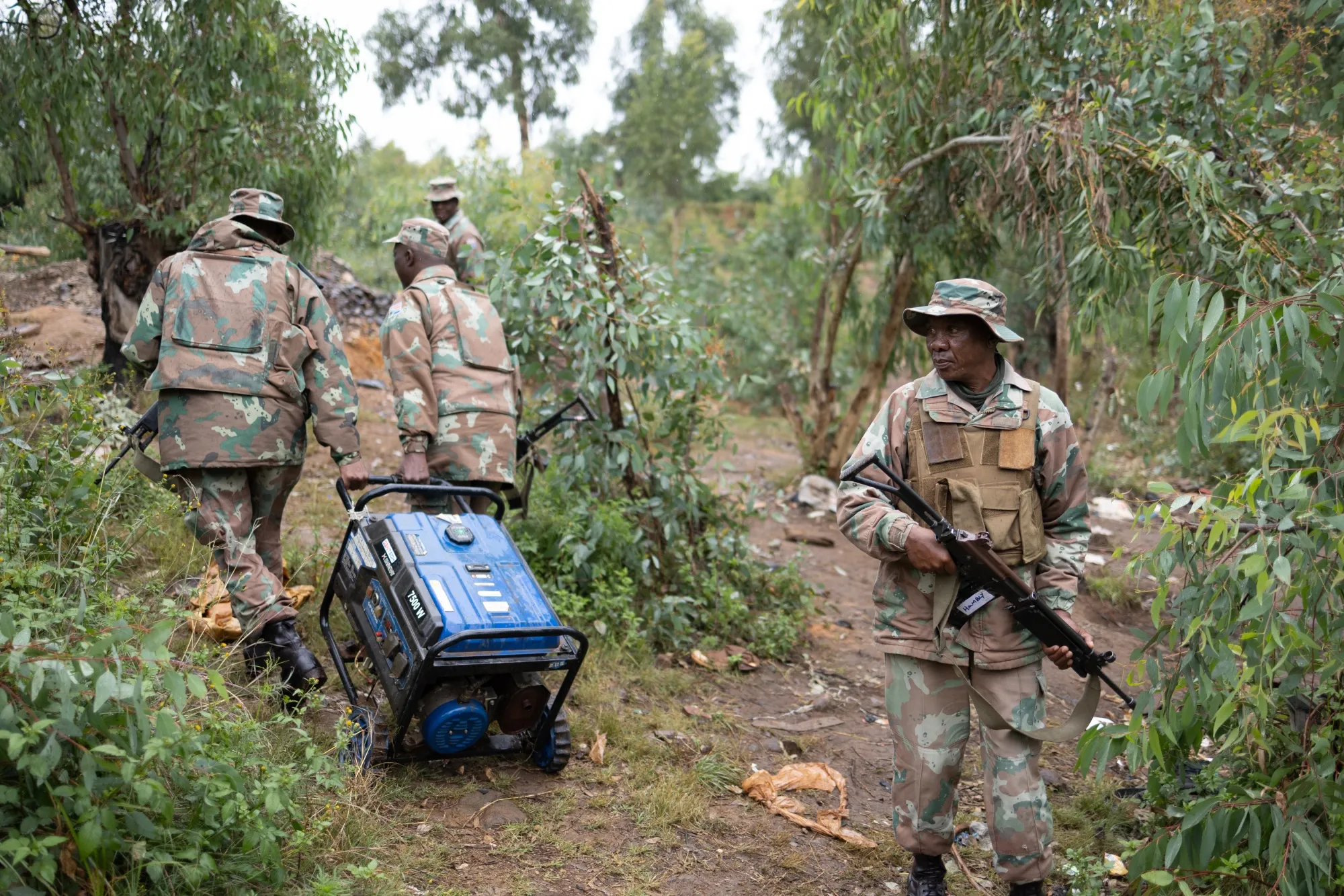 South African soldiers remove equipment used by informal miners in Randfontein near Johannesburg on March 12.