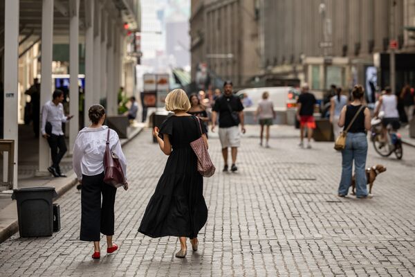 Pedestrians on Wall Street near the New York Stock Exchange (NYSE) in New York, US, on Monday, Sept. 16, 2024. 