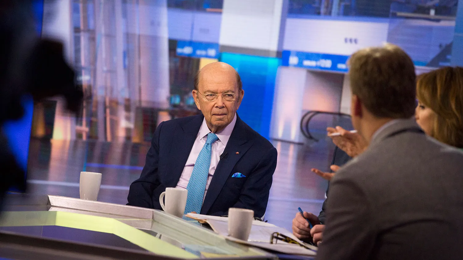 Wilbur Ross, chairman and chief executive officer of WL Ross Holding Corp., left, listens during a Bloomberg Television interview in New York on Oct. 20, 2015.
