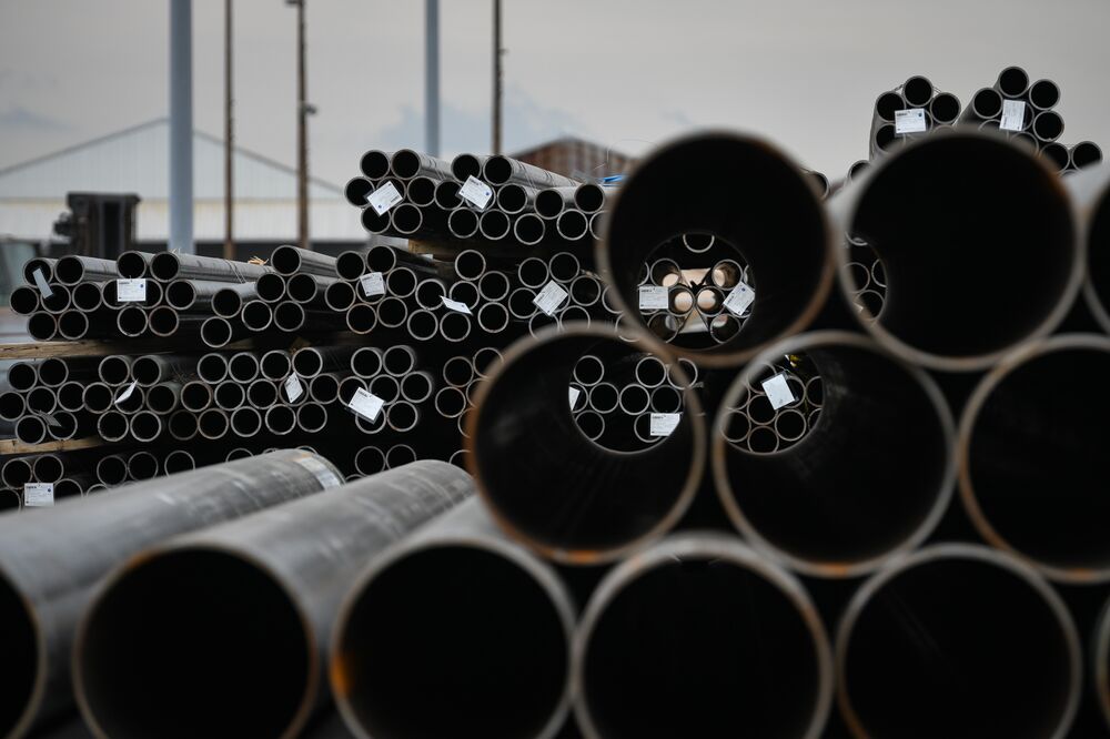 Steel pipes sit stacked at the Port of Houston, Texas.