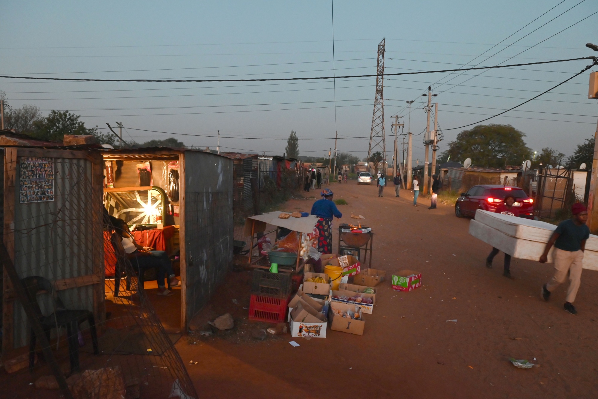 A vendor's stall open in the evening in the Slovo Park informal settlement outside Johannesburg, South Africa, on Friday, May 3, 2024. Slovo Park, established in 1993 when a farmer abandoned his property and people who worked in nearby industrial areas began dividing and occupying it amongst themselves, has seen little development despite a 2016 court ordering the government to build formal housing and only a fraction of households can access electricity provide by the state. Photographer: Leon Sadiki/Bloomberg