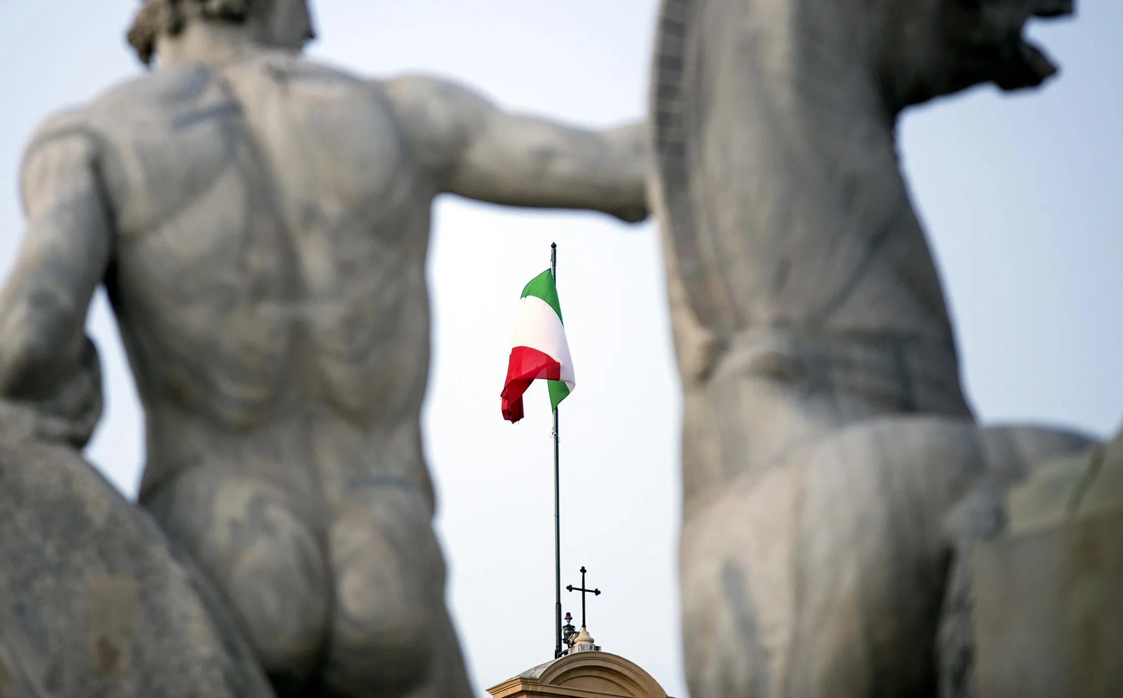 The Italian national flag flies above Quirinale palace.