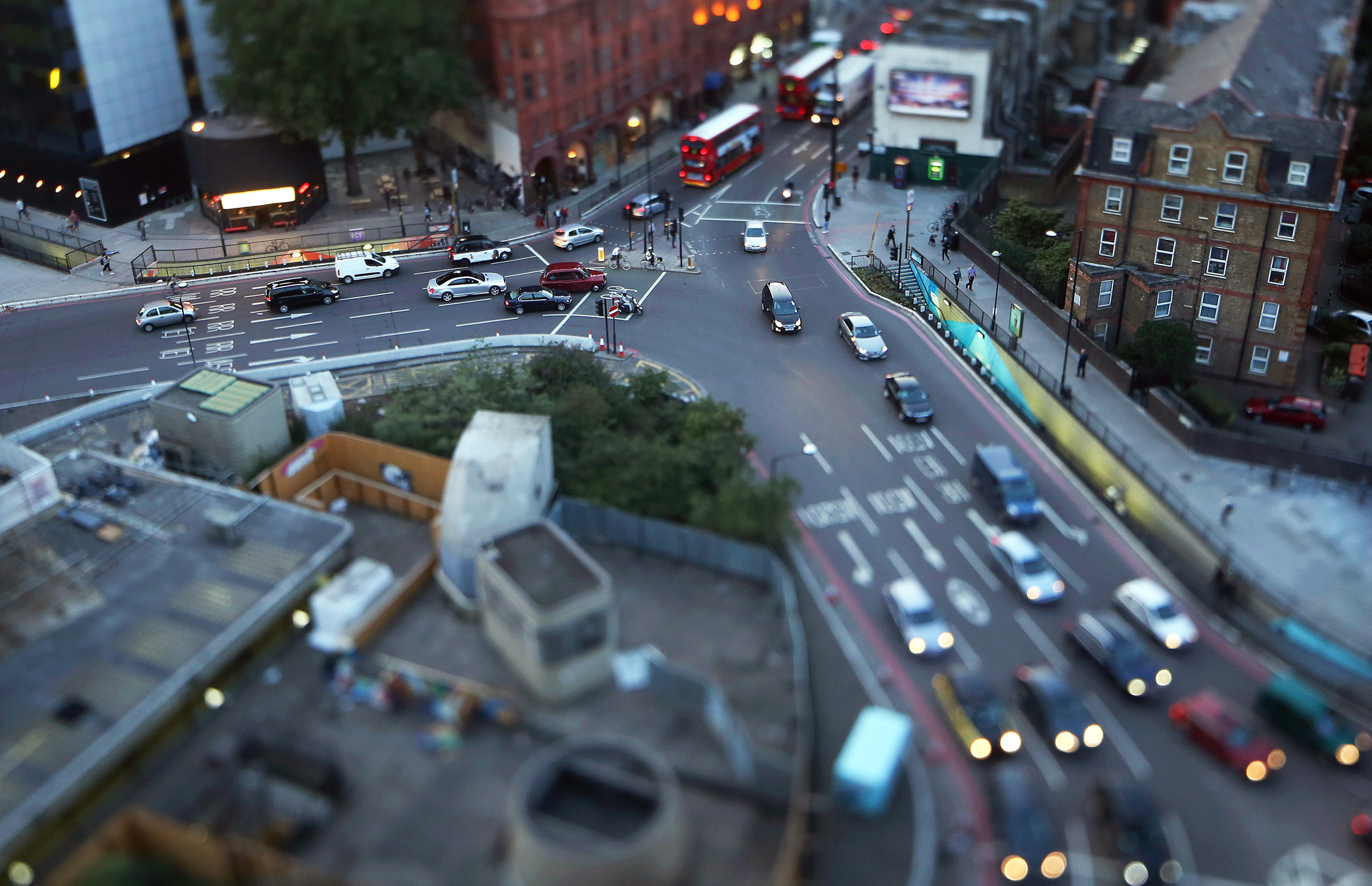 Traffic moves around the Old Street roundabout, also referred to as 'Silicon Roundabout,' in the area known as 'Tech City', in this photograph taken with a tilt-shift lens in London, U.K., on Wednesday, Aug. 20, 2014. Brookfield Asset Management Inc. is close to an agreement for Amazon.com Inc. to rent about 400,000 square feet (37,160 square meters) of office space near the London technology hub known as Silicon Roundabout, a person with knowledge of the talks said last month.
