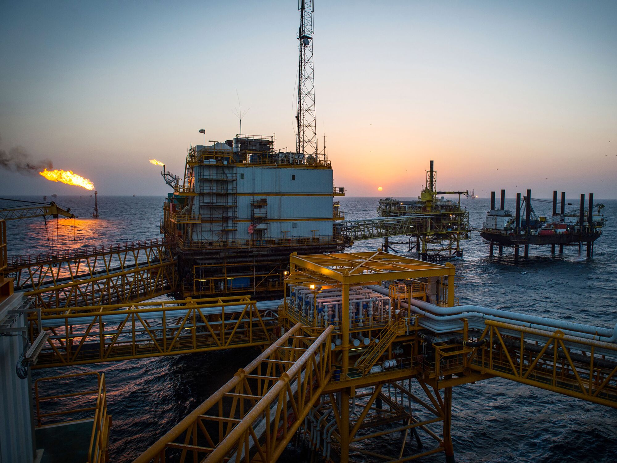 Gas flares burn from pipes aboard an offshore oil platform in the Persian Gulf's Salman Oil Field.