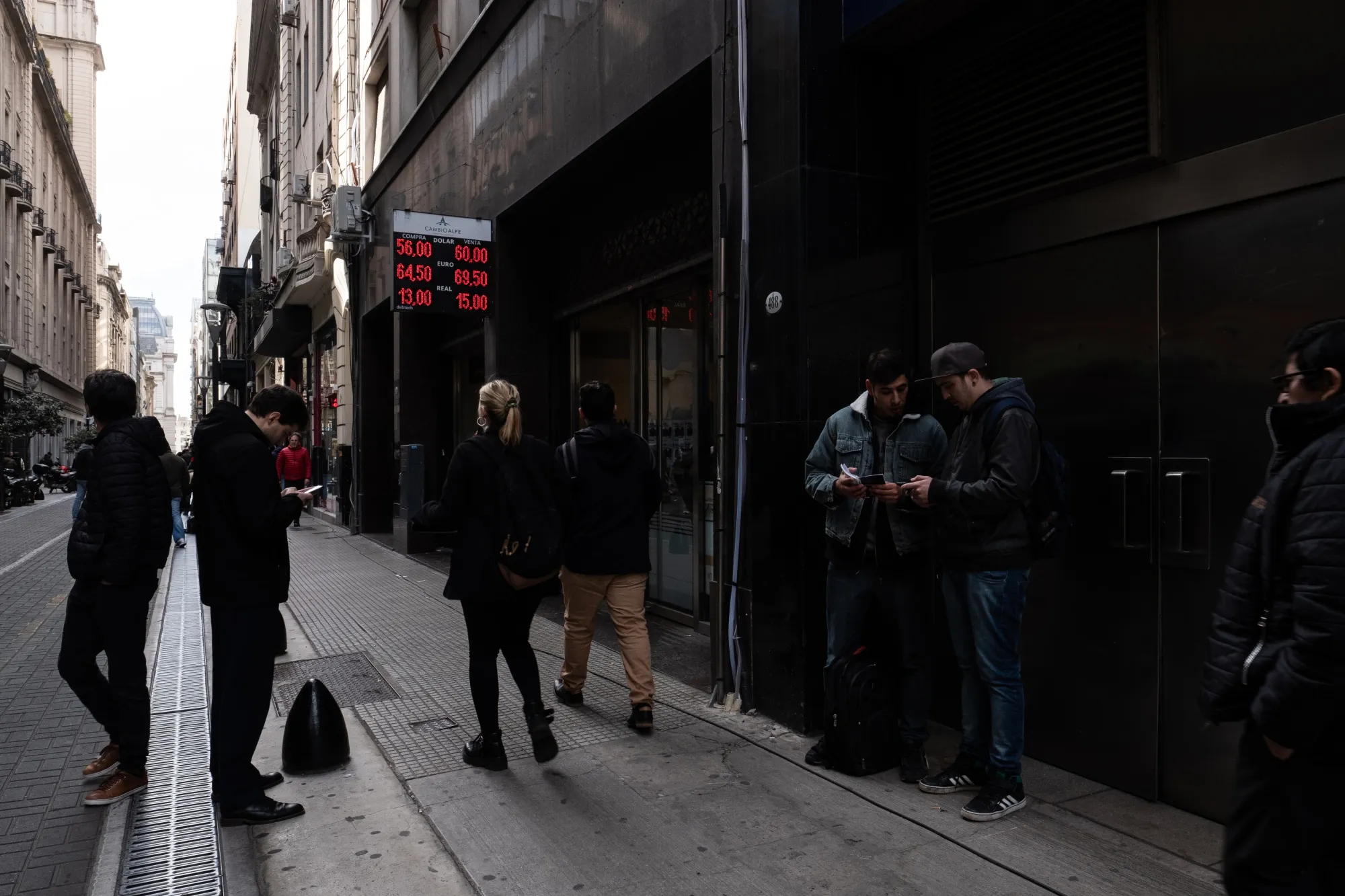 Pedestrians walk past a currency exchange in Buenos Aires on Sept. 2, 2019.