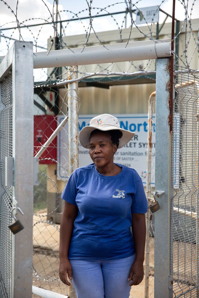 Nobuhle Dlulisa, 39, is one of the security guards that are hired to protect the the Clear Enviro Loo Recirculation Water Treatment Plant toilets 24 hours a day in Mofolo North informal settlement in Soweto, South Africa. The toilets are powered by solar panels, protected by security guards and serviced by janitors. These toilets replaced the chemical porta toilets that everyone once had to use. Photographer: Alexia Webster for Bloomberg Green