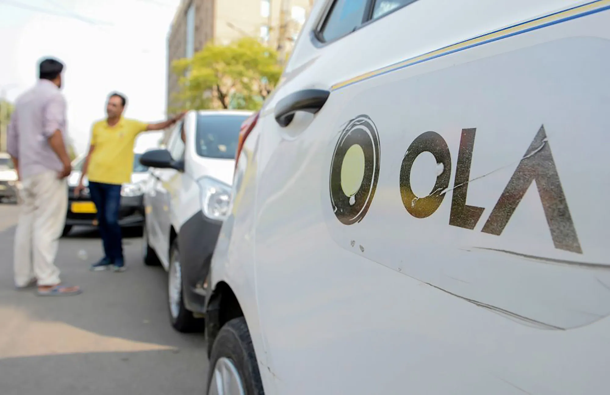 Ola cab drivers&nbsp;wait for passengers by a roadside in Amritsar, India.&nbsp;