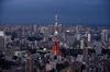 The Tokyo Tower, center, and commercial and residential buildings stand at dusk in Minato district of Tokyo, Japan.