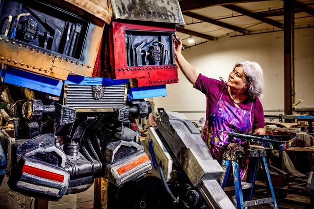 Tracey Thompson, Home Theme Orlando’s head artist, painting Transformers‑inspired decor.