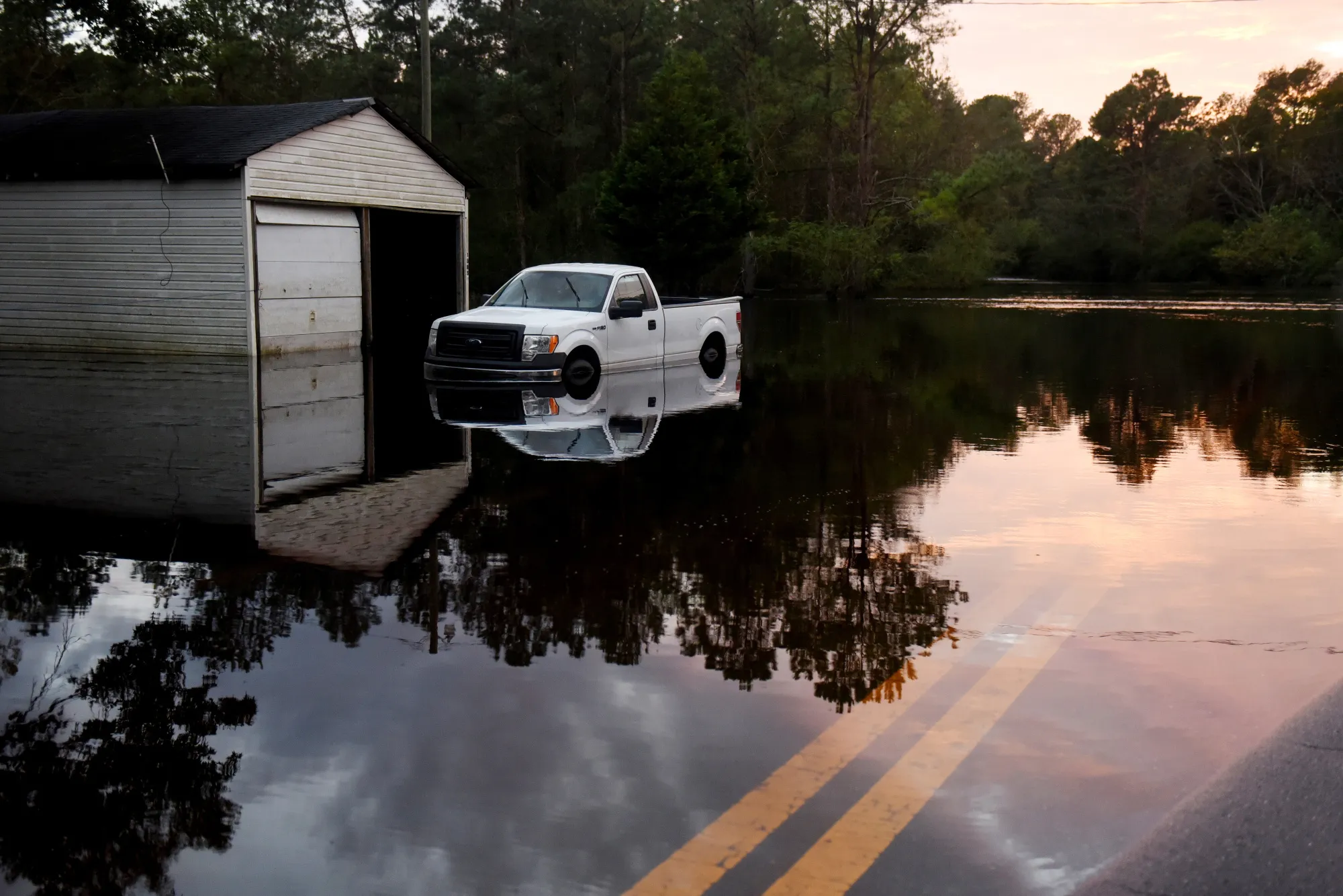 A vehicle sits partially submerged in floodwaters after Hurricane Florence hit in Beaulaville, North Carolina on Sept. 18, 2018.