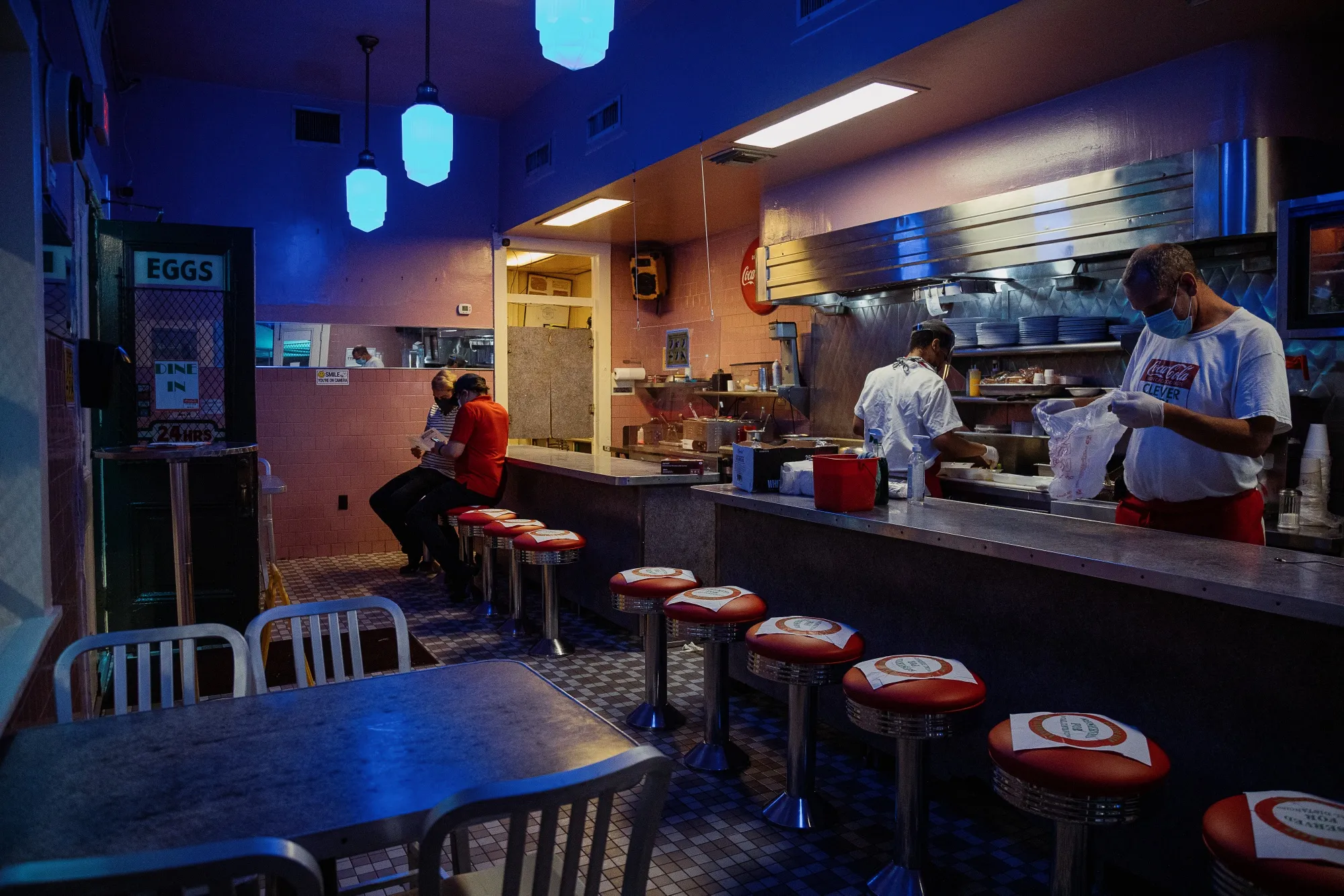 Customers sit as employees prepare food in a restaurant in New Orleans on May 16.