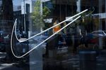 The Nike Inc. logo is displayed in the window of the Nike by Melrose live concept store in West Hollywood, California, U.S., on Monday, July 30, 2018.