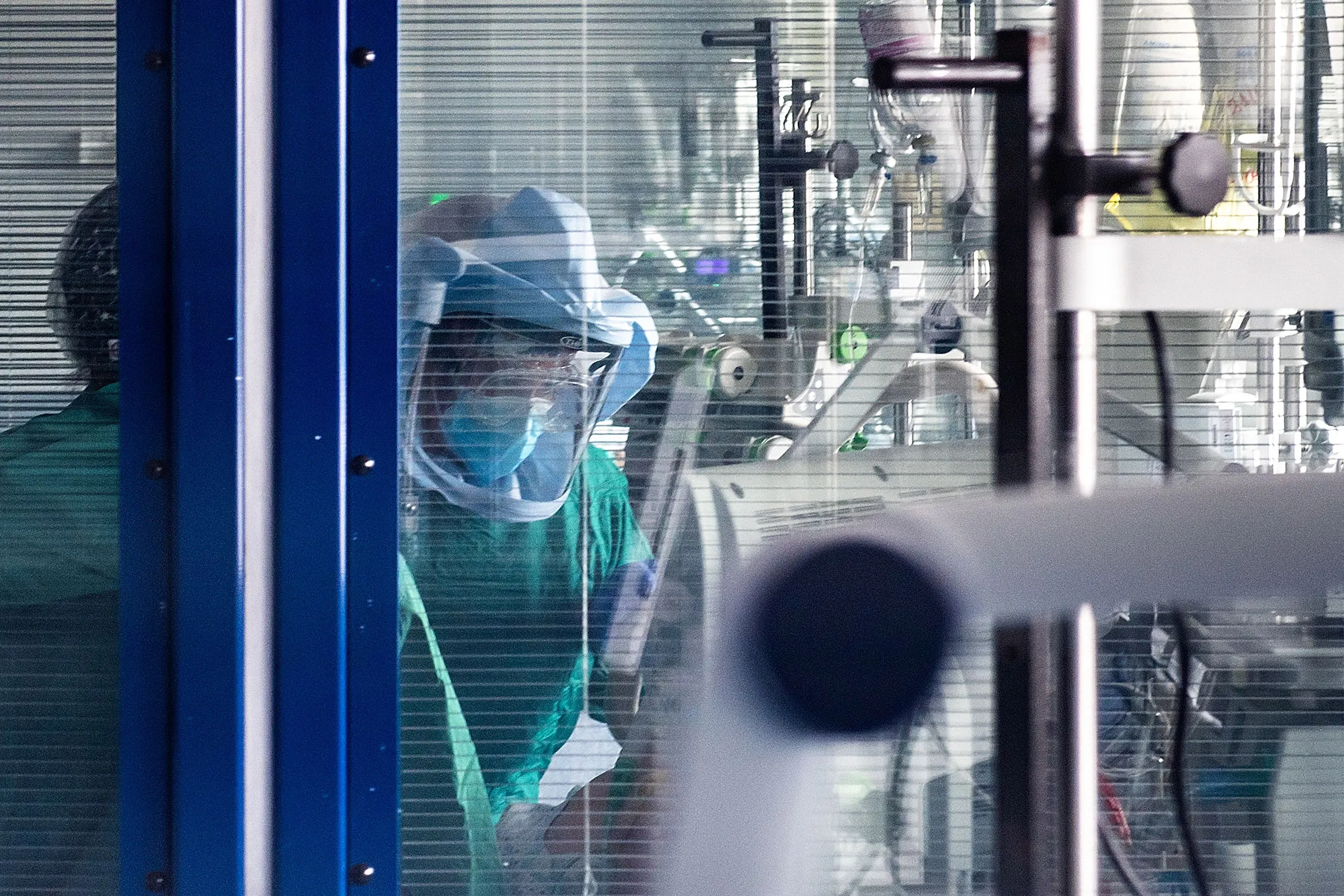 A medical worker wearing protective gear checks a patient's results at the Intensive Care Unit of the Tor Vergata hospital in Rome on April 21.