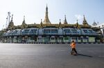 A municipal worker walks on an empty road in Yangon, on April 10.