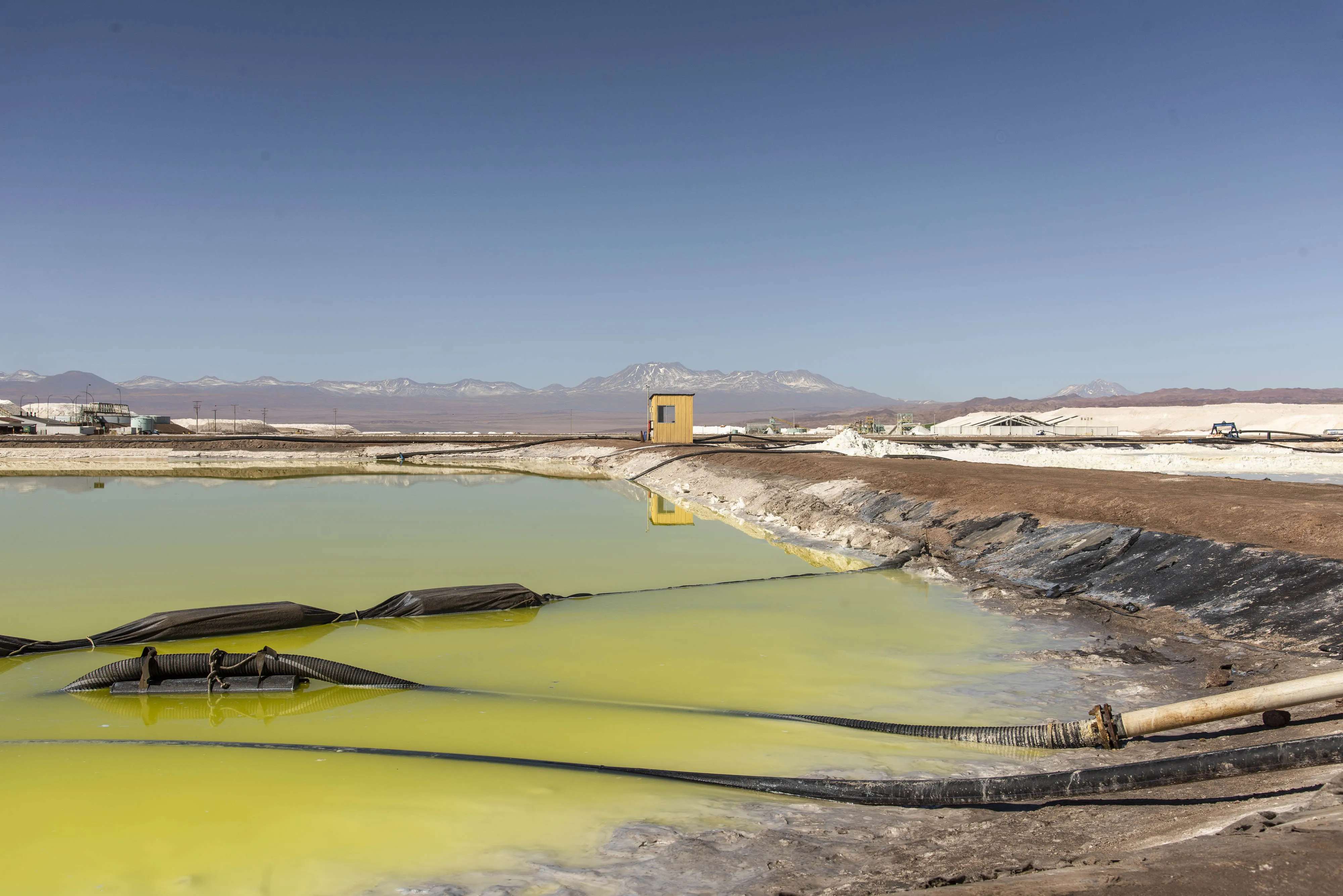 Pipes pump brine from a pool at the Albemarle Corp. Lithium mine in Calama, Antofagasta region, Chile, on Tuesday, July 20, 2021.&nbsp;