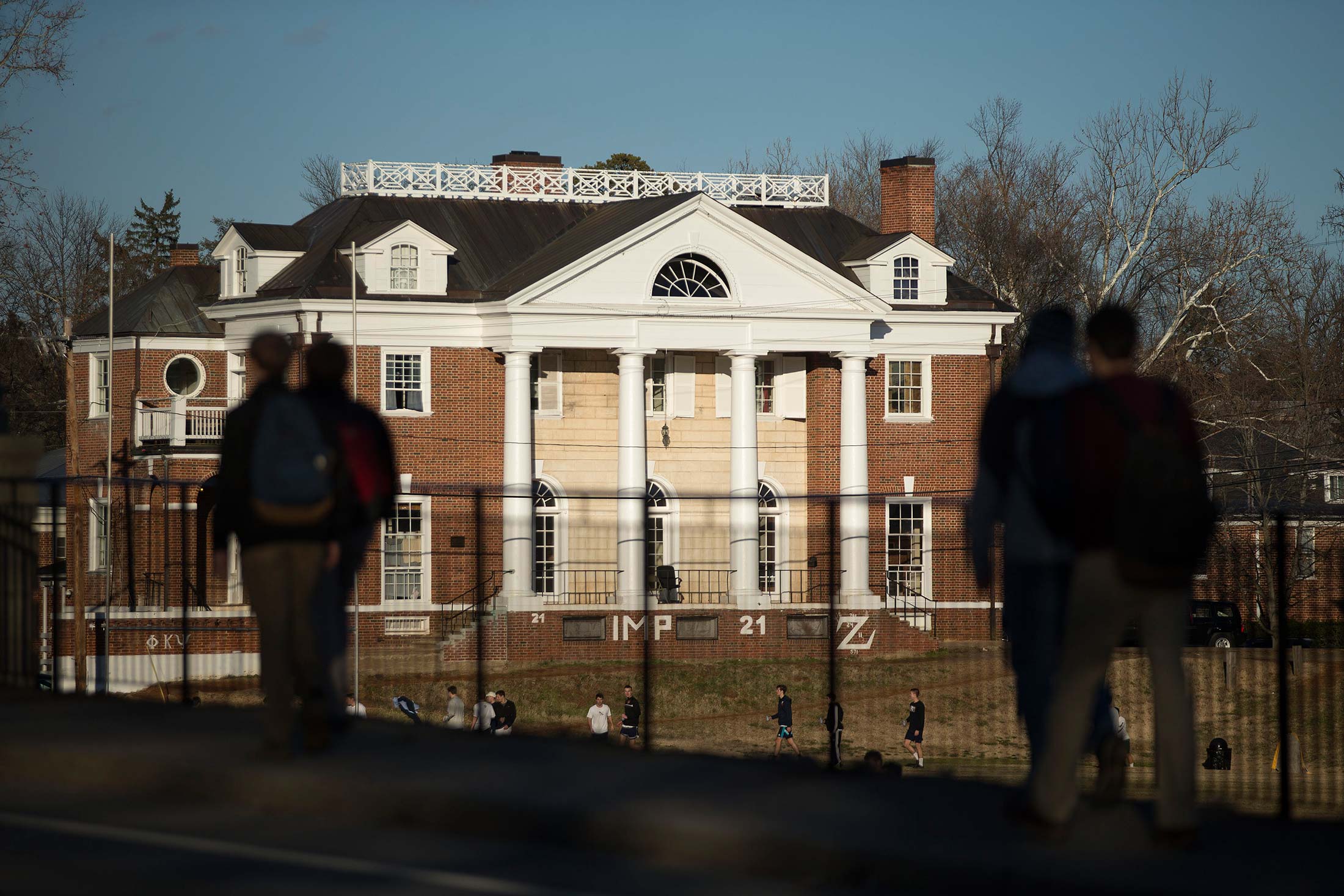 Students walk near the Phi Kappa Psi fraternity next to the University of Virginia (UVA) campus in Charlottesville, Virginia, on Jan. 16, 2015.
