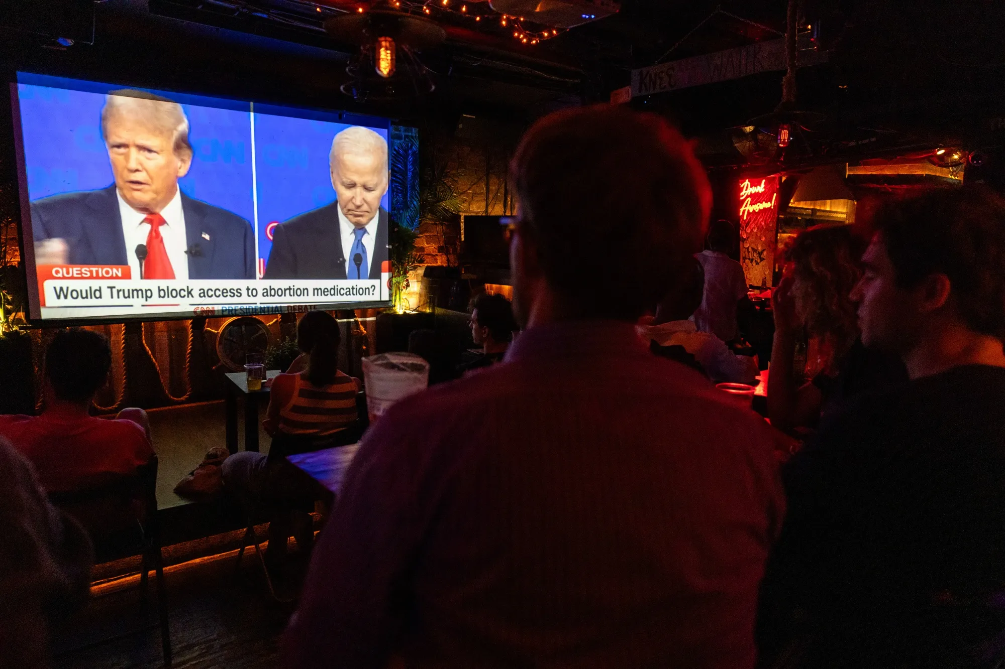 People watch the presidential debate between Joe Biden and&nbsp;Donald Trump in New York City on June 27.