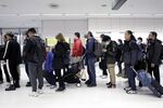Passengers wait in line to pass through a quarantine station at Narita Airport in Narita, Chiba Prefecture, Japan, on Thursday, Jan. 23, 2020.