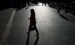 A woman walks near the Roppongi Hills complex in Tokyo.