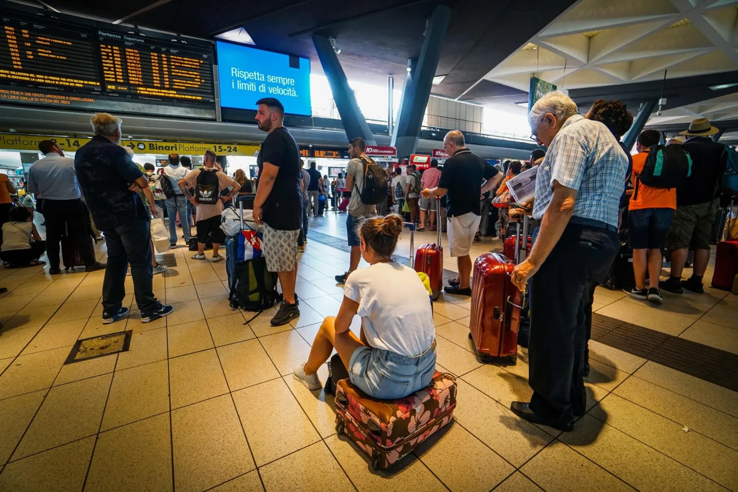 Passengers wait at Napoli Centrale train station in Naples on July 22.