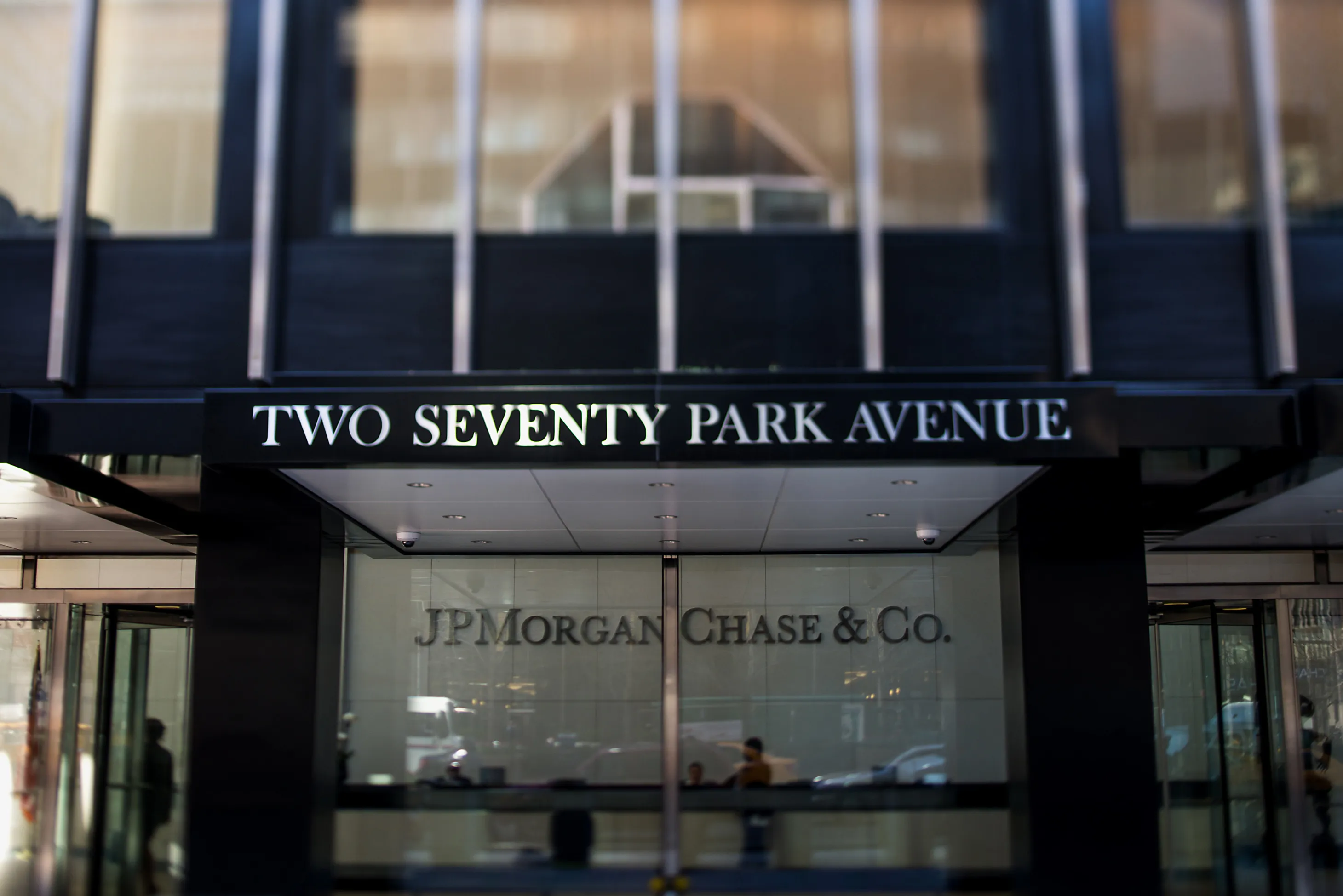 People stand inside the lobby of the JPMorgan Chase &amp; Co. headquarters building&nbsp;in New York.