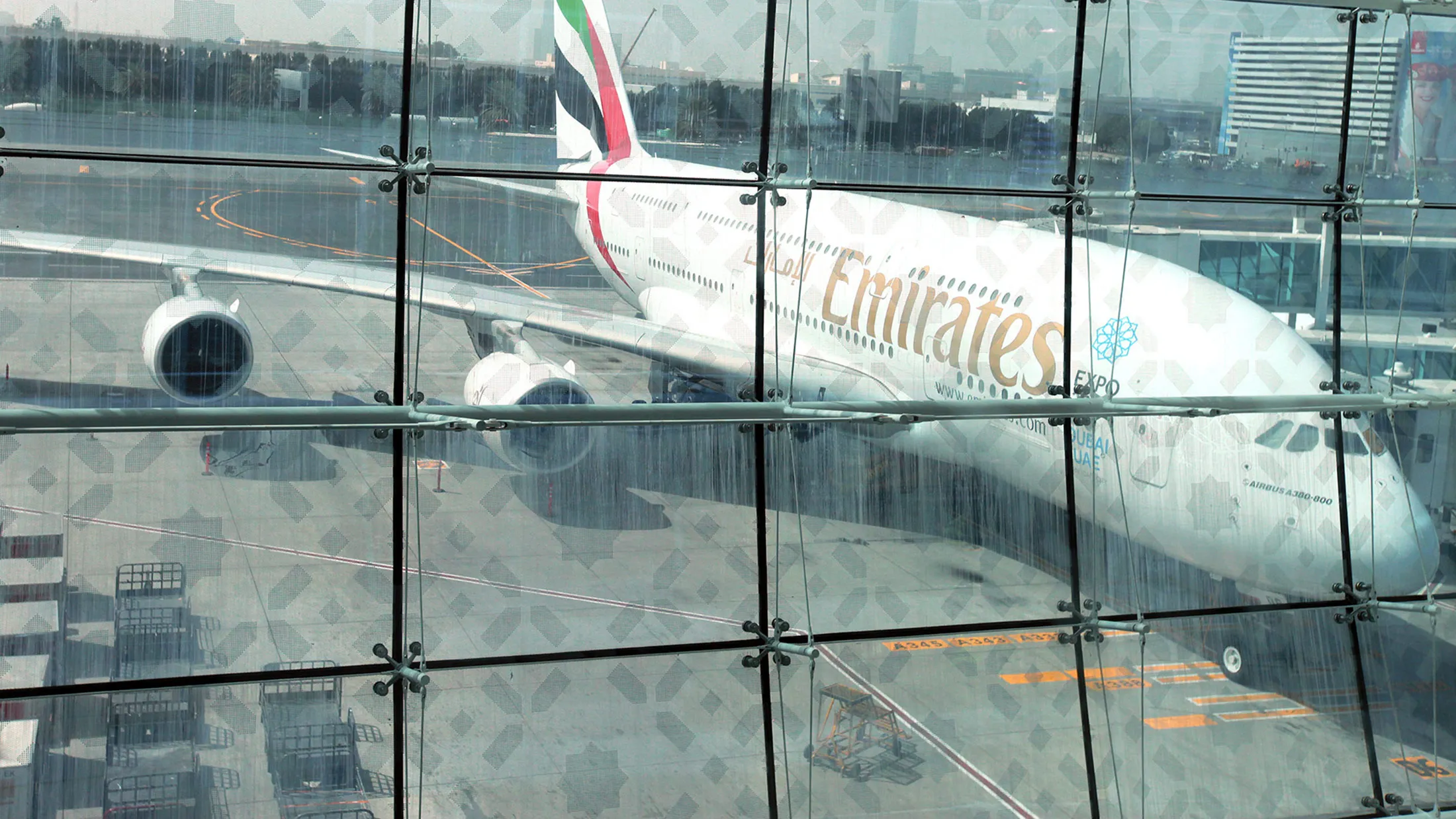 An Emirates Airline Airbus A380-800 aircraft is seen on the tarmac outside terminal 3 at concourse A, the new A380 terminal at Dubai International Airport in Dubai, United Arab Emirates, on Monday, Feb. 25, 2013. Dedicated for use by Emirates Airline the terminal 3 complex includes an associated airside facility known as Concourse B and a purpose-built facility for Airbus A380 known as Concourse A.
