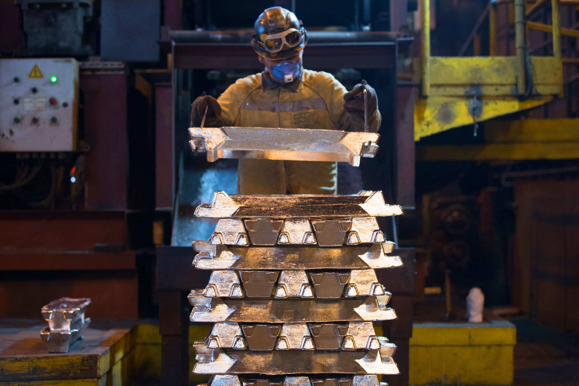 A worker stacks aluminum ingots to make ready for shipping at an aluminum smelter, operated by United Co. Rusal, in Krasnoyarsk, Russia.