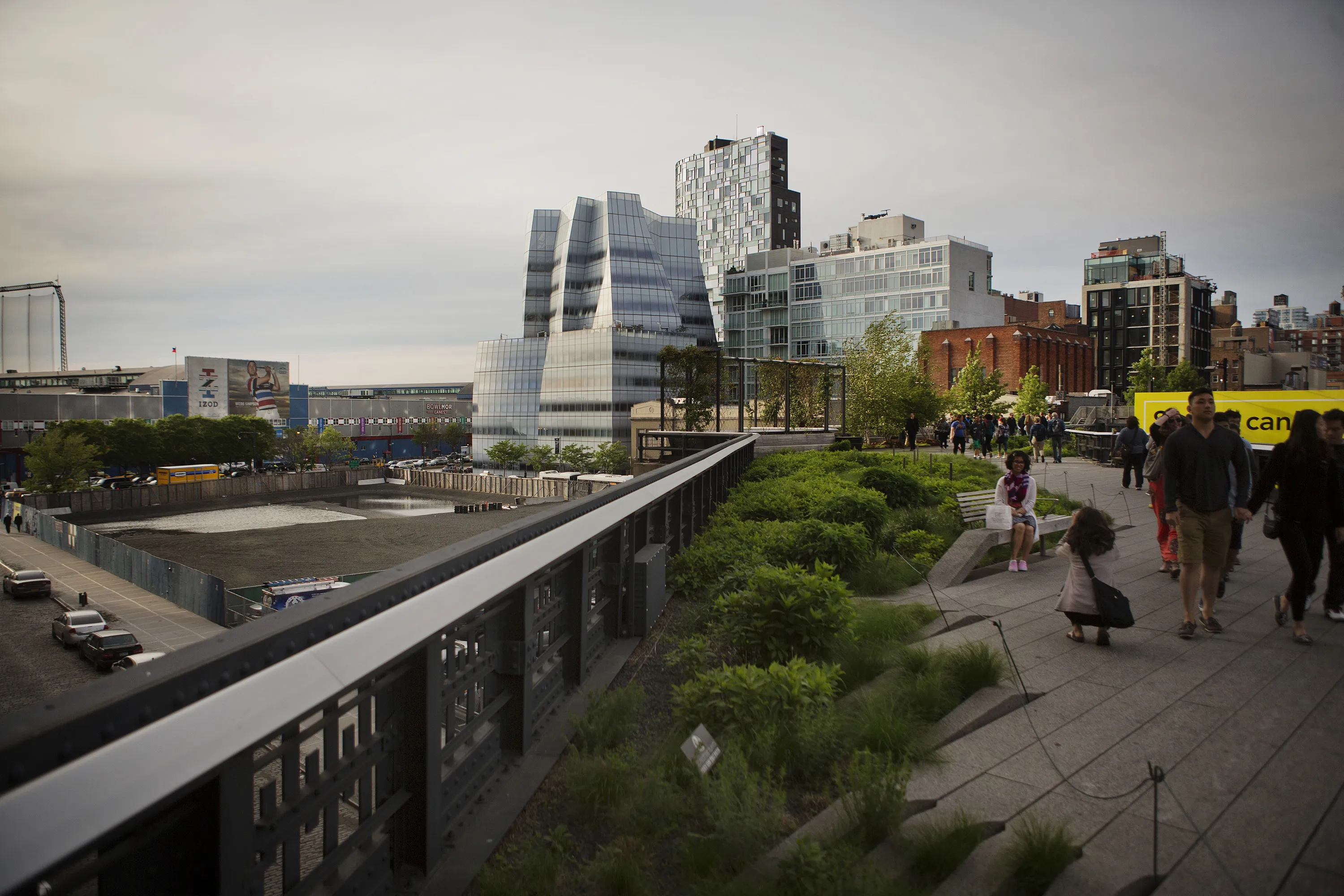 Visitors walk on the High Line next to the development site, left, purchased by Ziel Feldman's HFZ Capital Group. Photograph: Victor J. Blue/Bloomberg
