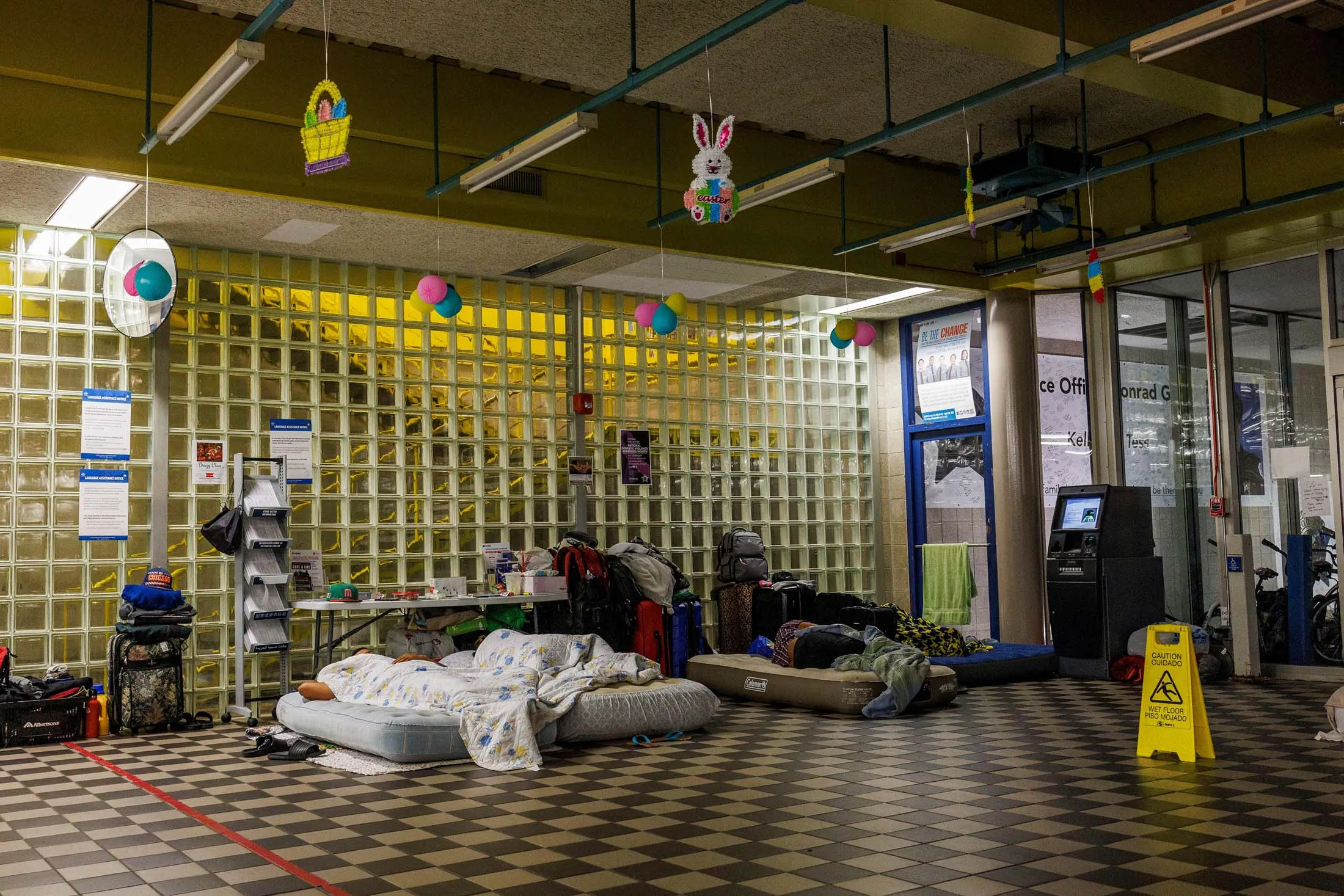 Asylum-seekers sleep in the lobby of a police station in Chicago on June 22.