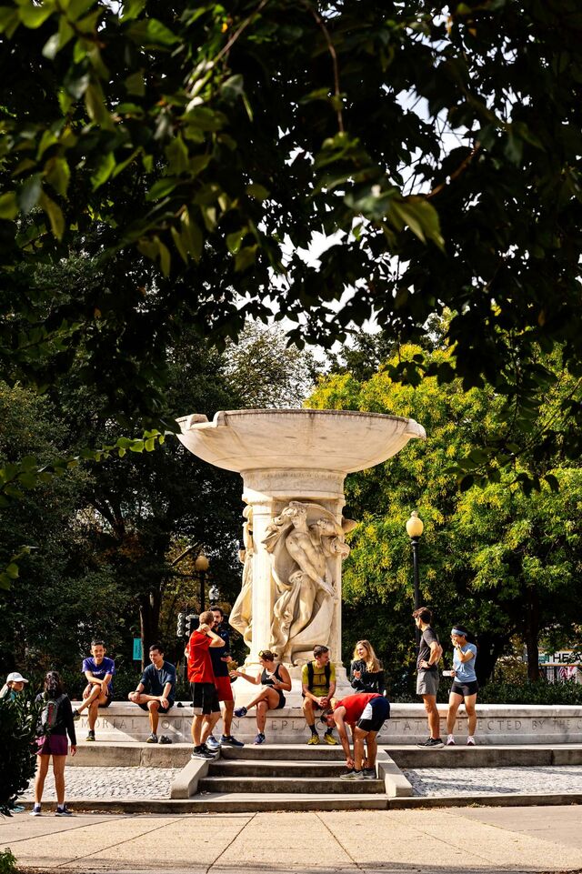People hang around the fountain at Dupont Circle.