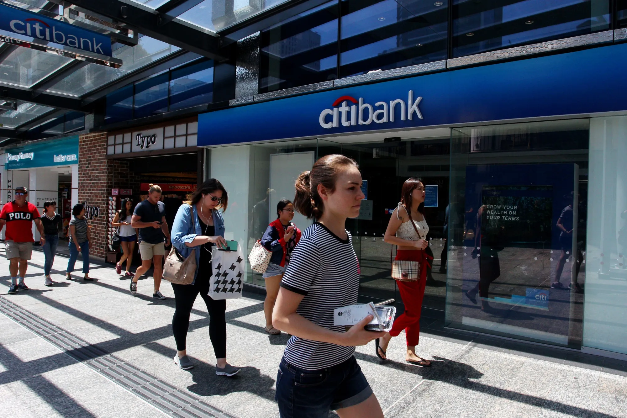 Pedestrians walk past a a Citigroup&nbsp;Citibank branch.