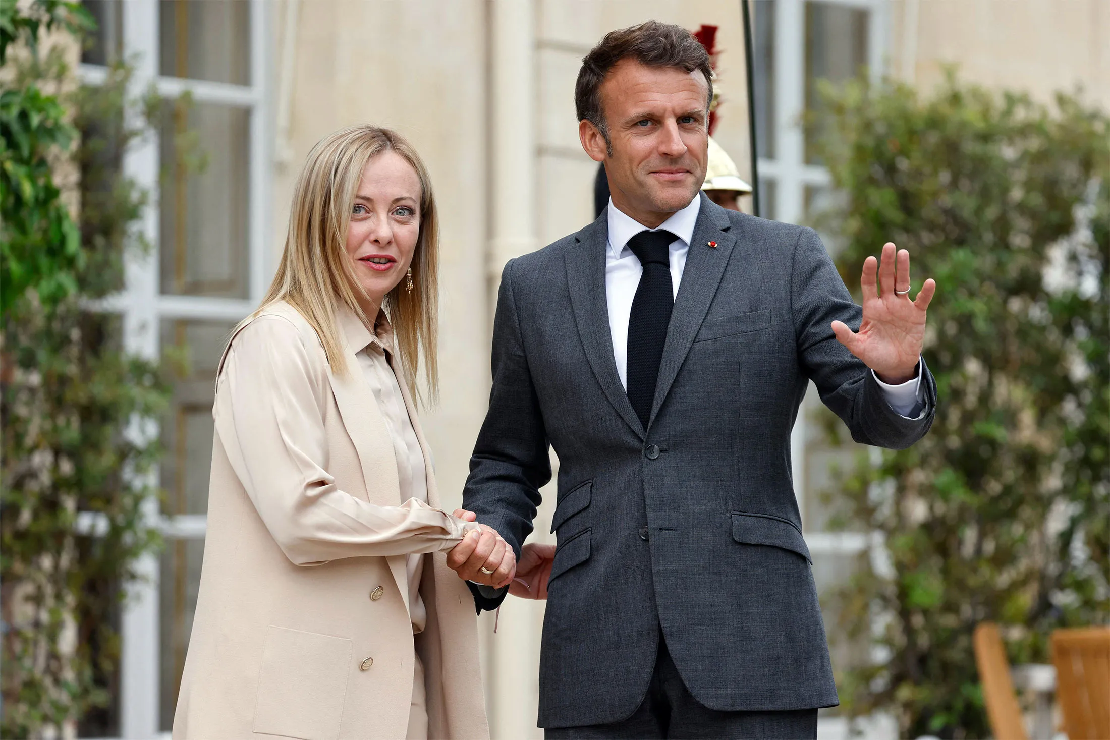 French President Emmanuel Macron (R) welcomes Italy's Prime Minister Giorgia Meloni at the Elysee Palace in Paris, on June 20, 2023.
