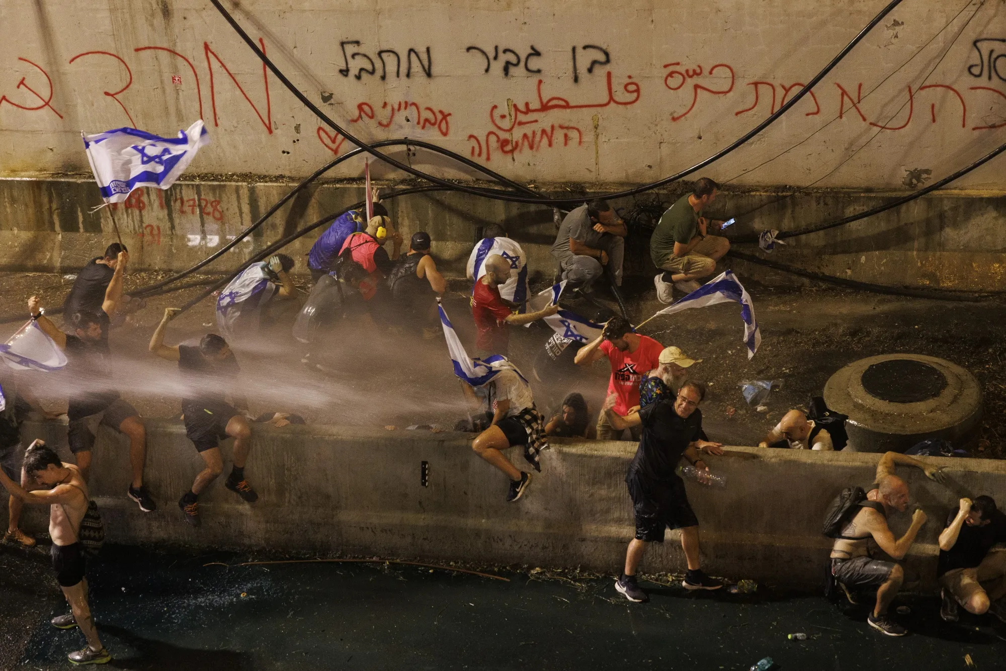 Police use water cannon on anti-government protesters during a demonstration outside the Knesset on July 24.