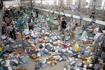 Chinese workers sort parcels, most of which come from online shopping, at a transshipment center in Nantong city, east Chinas Jiangsu province in 2013