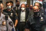 Allen Weisselberg, center, escorted towards a courtroom at criminal court in New York, on July 1.