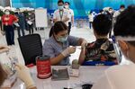 A health worker administers a dose of the CoronaVac Covid-19 vaccine in Suvarnabhumi Airport in Bangkok.