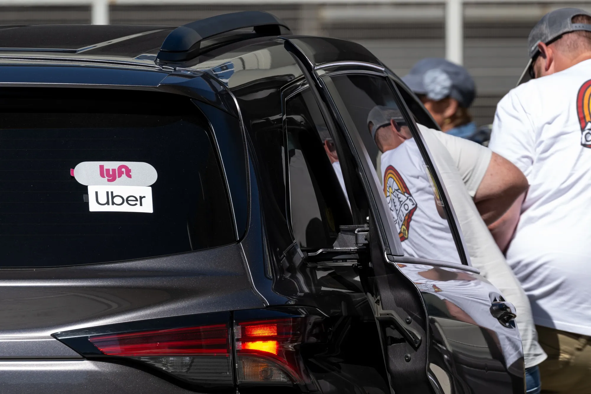 Uber and Lyft signage on a vehicle at San Francisco International Airport (SFO) in San Francisco on Sunday, Aug. 3, 2025.
