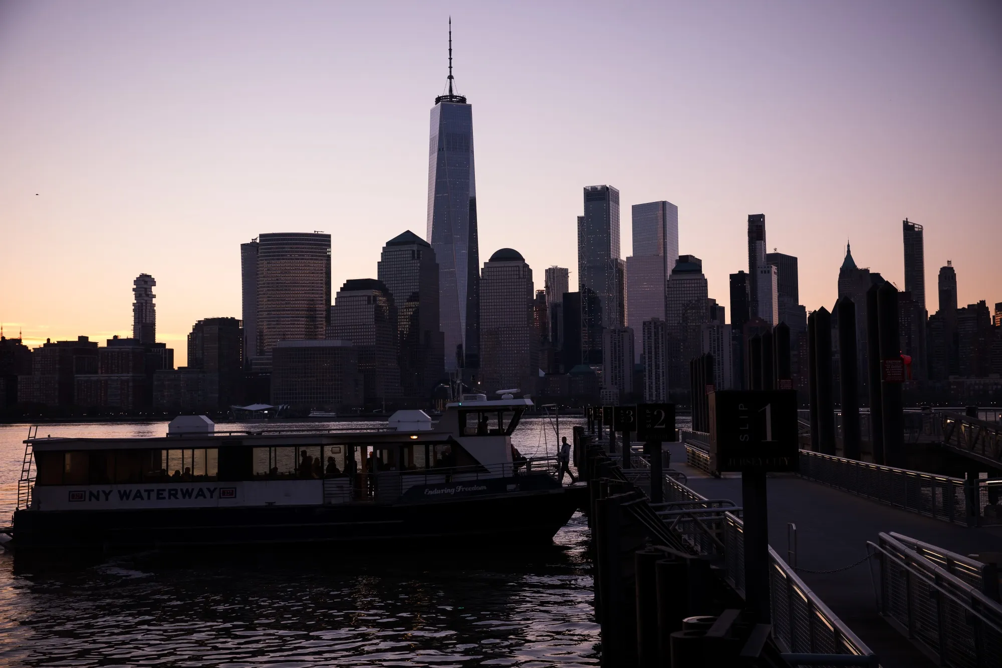 Commuters board a ferry in Jersey City, New Jersey.
