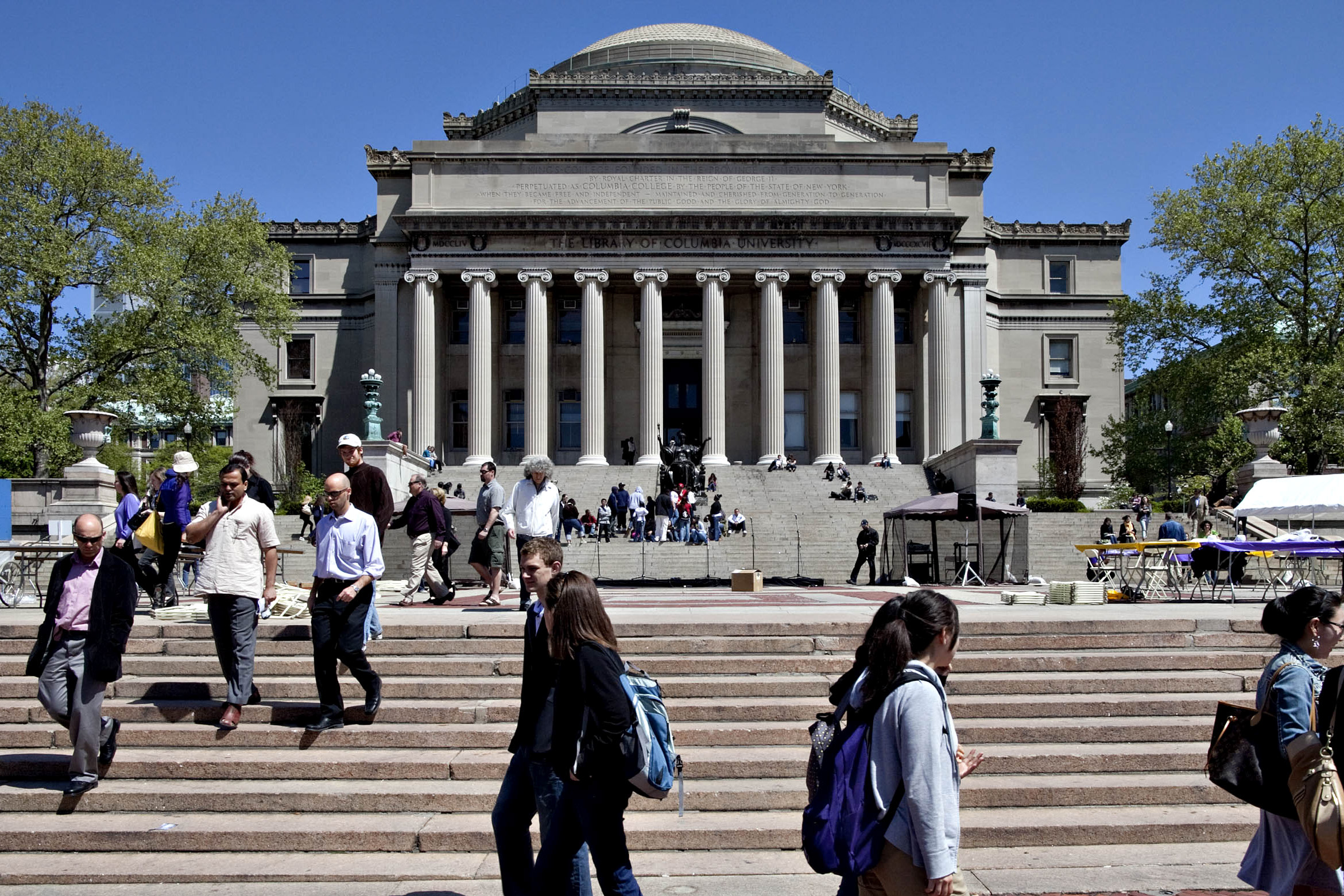Students and pedestrians walk outside the Low Memorial Library at the Columbia University campus in New York.