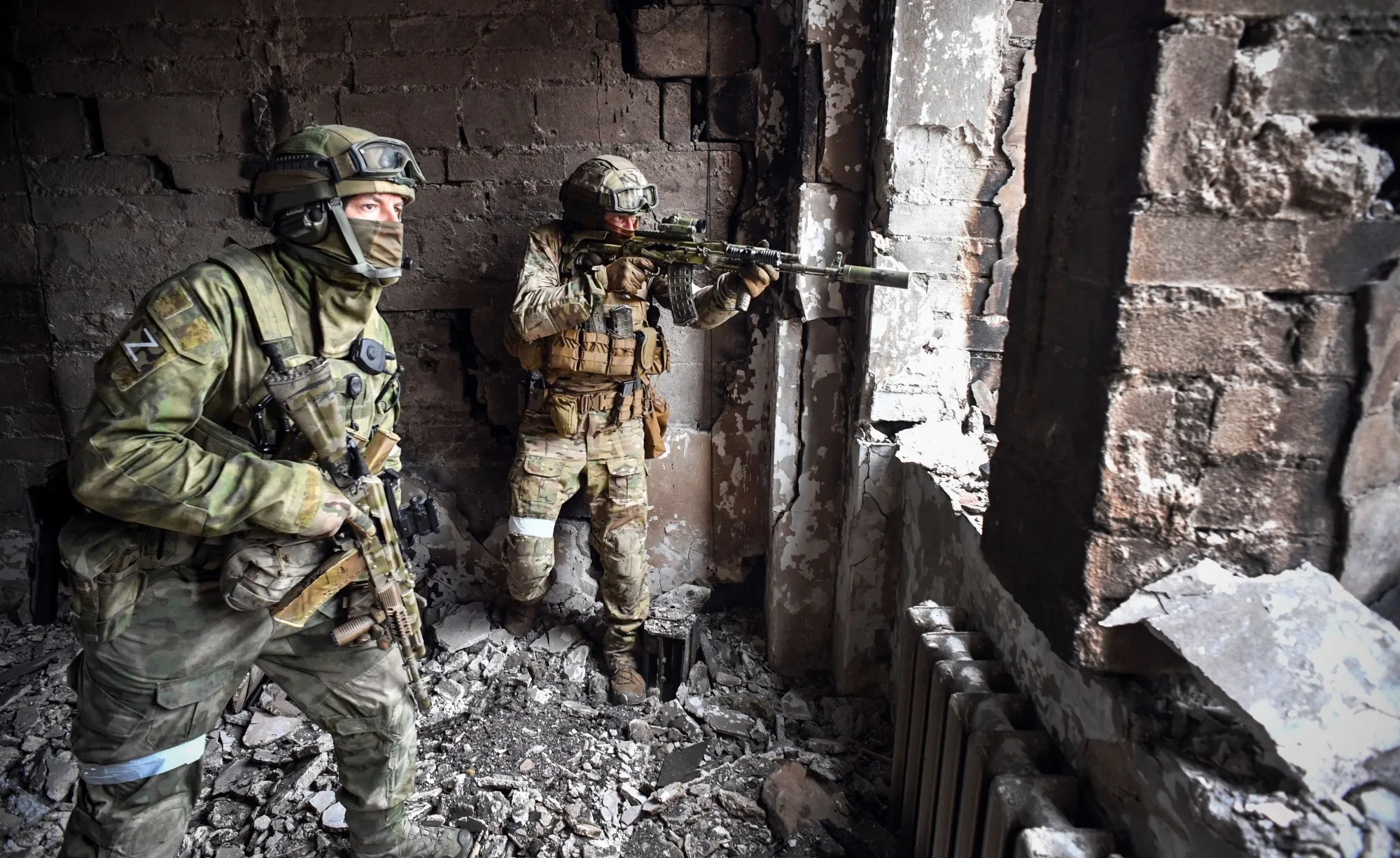During a media trip organized by the Russian military, Russian soldiers patrol at the Mariupol drama theatre in Mariupol, Ukraine, in April 2022.