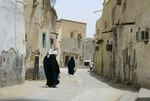 Saudi women walk in Riyadh's Shmeisy neighborhood.